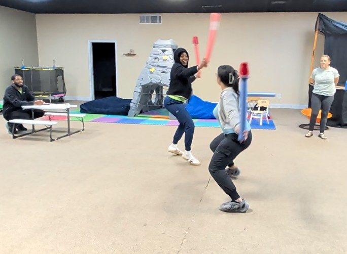 Two Killeen teammates defending a tower at the staff event